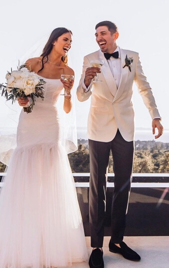 Andrew Schulz with his wife on their wedding day